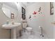 Stylish powder room features a pedestal sink, decorative accents, and tiled flooring at 10 Staghorn St, Henderson, NV 89012