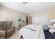 Comfortable bedroom featuring carpet floors, an accent chair and closet doors at 10 Staghorn St, Henderson, NV 89012