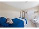 Cozy bedroom featuring neutral walls, blue bedding, and a comfortable chair at 10 Staghorn St, Henderson, NV 89012