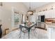 Charming dining area with a decorative chandelier, glass top table and direct access to the outdoor area at 10 Staghorn St, Henderson, NV 89012