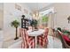 Cozy dining area with a chandelier, bright windows, and a white round table with red and white checkered chairs at 10 Staghorn St, Henderson, NV 89012
