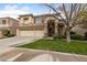 Charming two-story home featuring a spacious three-car garage and well-manicured front yard at 10 Staghorn St, Henderson, NV 89012