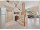 Bright foyer featuring a grand staircase with wood railings, tile flooring, and an open view to the living area at 10 Staghorn St, Henderson, NV 89012