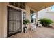Inviting covered front porch with seating area and decorative tiled flooring at 10 Staghorn St, Henderson, NV 89012