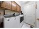 Functional laundry room equipped with washer, dryer, and overhead cabinets for efficient storage at 10 Staghorn St, Henderson, NV 89012