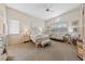 Spacious main bedroom with a ceiling fan, large windows, and stylish furnishings at 10 Staghorn St, Henderson, NV 89012
