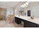 Elegant bathroom featuring double sinks, a large mirror, a walk-in shower, and a separate toilet area at 10500 Pacific Palisades Ave, Las Vegas, NV 89144