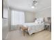 Cozy bedroom features soft lighting, light walls, and a cushioned bench at 10500 Pacific Palisades Ave, Las Vegas, NV 89144