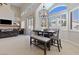 Bright dining area with a modern chandelier and ample natural light from large windows at 10500 Pacific Palisades Ave, Las Vegas, NV 89144