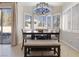 Cozy dining space with a view of the pool area and natural light from shuttered windows at 10500 Pacific Palisades Ave, Las Vegas, NV 89144