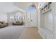 Inviting entryway featuring a built-in bench with storage and lots of natural light from the large windows at 10500 Pacific Palisades Ave, Las Vegas, NV 89144