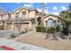 Charming home with a well-manicured lawn, mature trees, and a welcoming entrance at 10500 Pacific Palisades Ave, Las Vegas, NV 89144