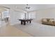 Versatile game room with a full size ping pong table, neutral carpet, and lots of natural light at 10500 Pacific Palisades Ave, Las Vegas, NV 89144