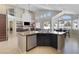 Spacious kitchen featuring a center island, stainless steel appliances, and an open layout to the living area at 10500 Pacific Palisades Ave, Las Vegas, NV 89144