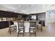Gourmet kitchen with center island, seating, dark cabinets and granite countertops at 10500 Pacific Palisades Ave, Las Vegas, NV 89144