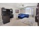 Versatile living space featuring a built-in desk, a blue sofa, and natural light from large windows at 10500 Pacific Palisades Ave, Las Vegas, NV 89144