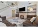 Cozy living room featuring a stone fireplace, media center, and comfortable seating at 10500 Pacific Palisades Ave, Las Vegas, NV 89144