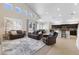 Open-concept living room with hardwood flooring, natural lighting, and an adjacent kitchen at 10500 Pacific Palisades Ave, Las Vegas, NV 89144