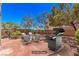 Backyard patio with outdoor seating and a grill for relaxation and entertainment, providing a virtually staged appearance at 11178 Corsica Mist Ave, Las Vegas, NV 89135