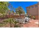 Backyard patio featuring outdoor seating and a grill, ideal for relaxing and entertaining with a virtually staged look at 11178 Corsica Mist Ave, Las Vegas, NV 89135