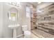 Modern bathroom featuring glass shower with tiled walls and pedestal sink at 11178 Corsica Mist Ave, Las Vegas, NV 89135