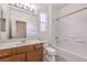 Bathroom with wood vanity, white tile, and bathtub/shower combo at 11178 Corsica Mist Ave, Las Vegas, NV 89135