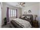 Cozy bedroom featuring neutral decor, ceiling fan, shutters, and ample natural light at 11178 Corsica Mist Ave, Las Vegas, NV 89135