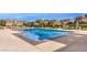 Large community pool with lounge chairs and umbrellas, offering a relaxing and luxurious outdoor experience at 11178 Corsica Mist Ave, Las Vegas, NV 89135
