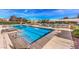 Spacious community pool with lounge chairs and covered areas, designed for ultimate relaxation and leisure at 11178 Corsica Mist Ave, Las Vegas, NV 89135