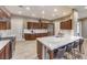 Spacious kitchen featuring stainless steel appliances, a center island, and dark wood cabinetry at 11178 Corsica Mist Ave, Las Vegas, NV 89135