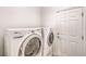 Clean laundry area featuring a modern washer and dryer set and a door to outside at 11178 Corsica Mist Ave, Las Vegas, NV 89135
