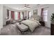 Spacious main bedroom featuring large windows, sitting area, and neutral decor at 11178 Corsica Mist Ave, Las Vegas, NV 89135