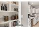 Pantry with built-in shelves next to a kitchen with stainless steel appliances at 11178 Corsica Mist Ave, Las Vegas, NV 89135