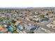 Expansive aerial view of a neighborhood featuring well-maintained homes and several private pools in a sunny, suburban setting at 1912 Parkchester Dr, Las Vegas, NV 89108