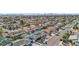 Sweeping aerial view of a neighborhood featuring homes with pools, mature landscaping, and city skyline at 1912 Parkchester Dr, Las Vegas, NV 89108
