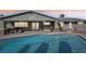 Inviting backyard with a refreshing pool, covered patio, and outdoor seating, perfect for relaxation and entertainment at 1912 Parkchester Dr, Las Vegas, NV 89108