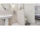 Bright bathroom featuring a pedestal sink, tile walls, and separate toilet at 1912 Parkchester Dr, Las Vegas, NV 89108