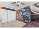 Bedroom featuring a queen sized bed, custom car engine wall graphic, and a closet with white doors at 1912 Parkchester Dr, Las Vegas, NV 89108