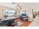 Bright dining area featuring a ceiling fan, wood floors, natural light, and a connected seating area at 1912 Parkchester Dr, Las Vegas, NV 89108