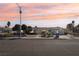 Charming single-story home with desert landscaping, solar panels, and a spacious two-car garage under a colorful sky at 1912 Parkchester Dr, Las Vegas, NV 89108