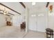 Inviting foyer with tiled flooring, exposed wood beam, and abundant natural light at 1912 Parkchester Dr, Las Vegas, NV 89108