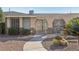 Unique desert home with arched front gate, low maintenance landscaping, and solar panels on the roof at 1912 Parkchester Dr, Las Vegas, NV 89108
