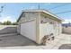 Detached garage with white door and light green exterior, offering secure parking and additional storage at 1912 Parkchester Dr, Las Vegas, NV 89108