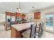 Open kitchen featuring stainless steel appliances, kitchen island, and access to backyard pool at 1912 Parkchester Dr, Las Vegas, NV 89108