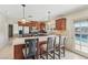 Bright kitchen with island seating and stainless appliances, featuring a door to the outdoor pool at 1912 Parkchester Dr, Las Vegas, NV 89108
