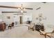 Spacious living room area with carpet flooring, beamed ceilings, and multiple seating areas at 1912 Parkchester Dr, Las Vegas, NV 89108