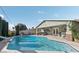 Backyard pool with a slide and patio seating area, ideal for outdoor entertaining at 1912 Parkchester Dr, Las Vegas, NV 89108