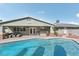 Backyard featuring pool, patio, and outdoor kitchen, perfect for entertaining guests at 1912 Parkchester Dr, Las Vegas, NV 89108
