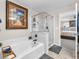 Bright bathroom featuring a soaking tub, glass shower, and modern fixtures at 2005 Via Firenze, Henderson, NV 89044
