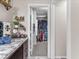 Bathroom featuring a vanity with granite countertop, built-in storage, and a view into the closet at 2005 Via Firenze, Henderson, NV 89044